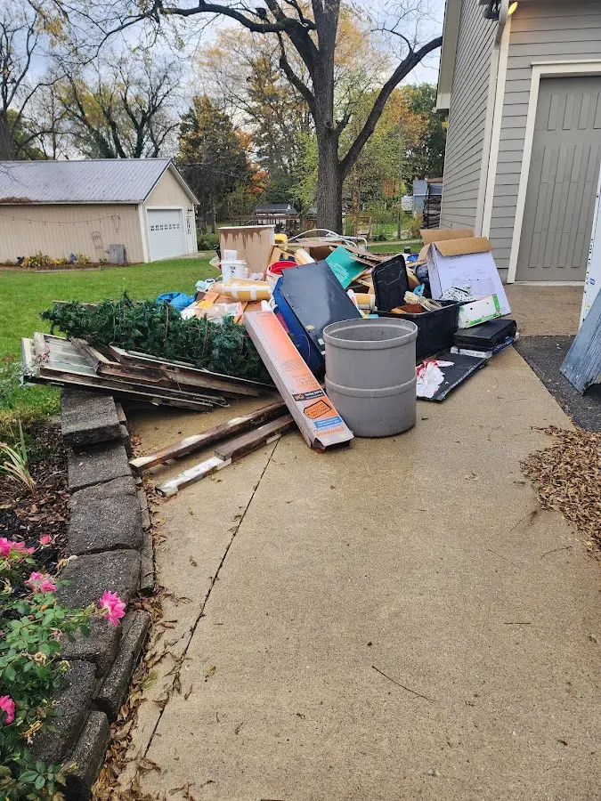 Dumpster being loaded with debris for Estate Cleanout Dumpster Rental in Scenic Oaks